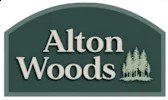 A green sign with white text that says Alton Woods.